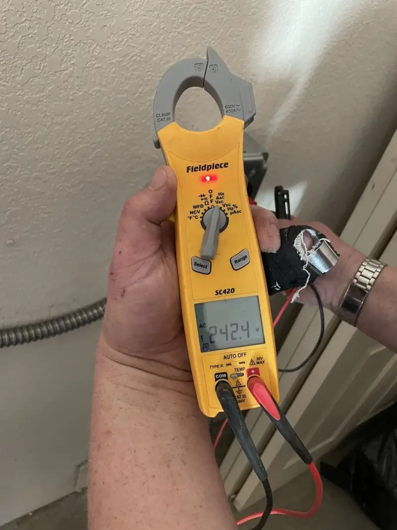 Voltage testing with clamp meter during Ceiling Fan Installation in Dexter